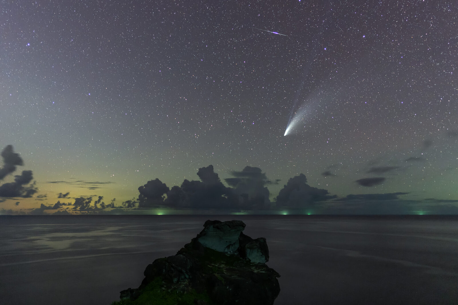 A comet over the sea at twilight