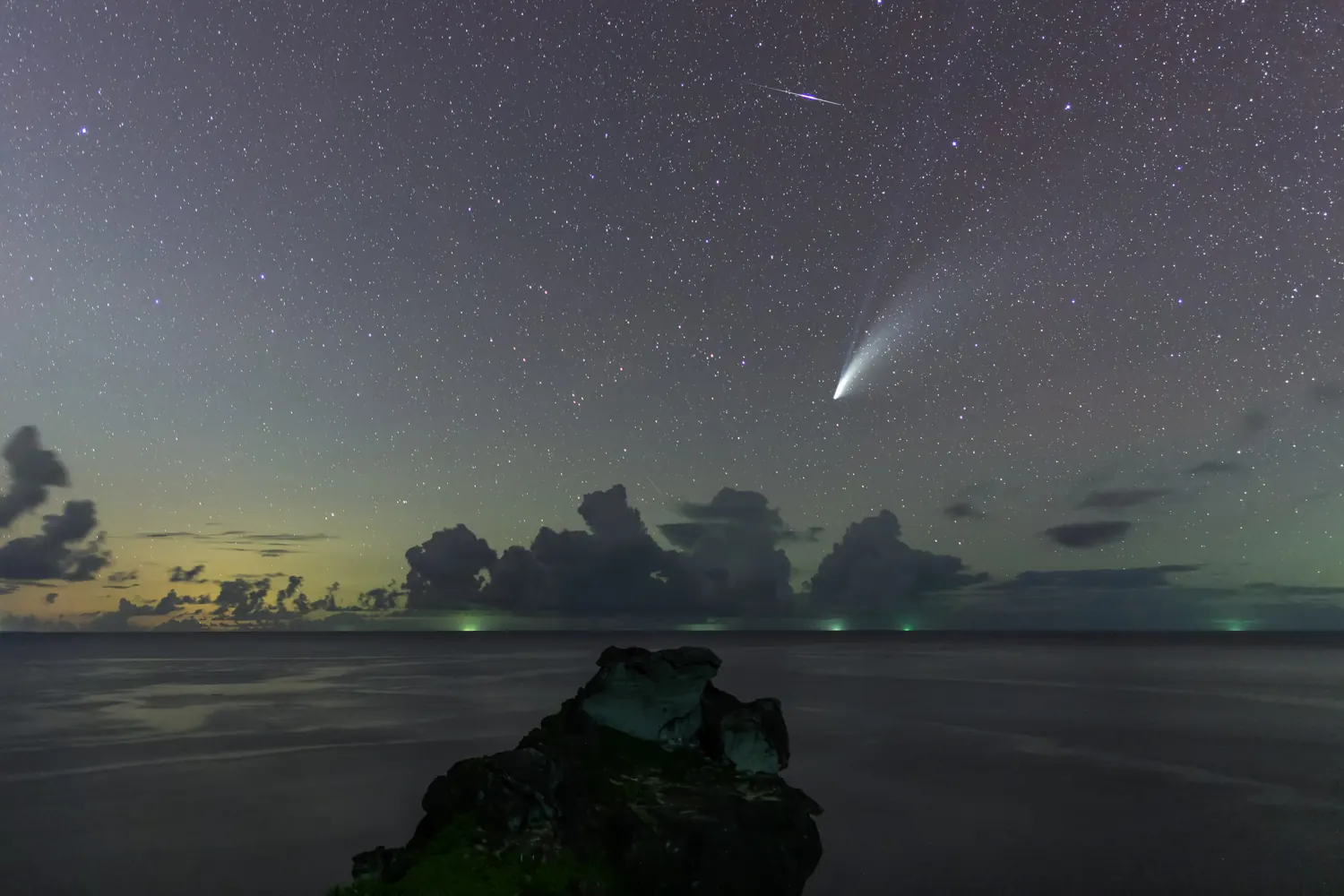 A comet over the sea at twilight