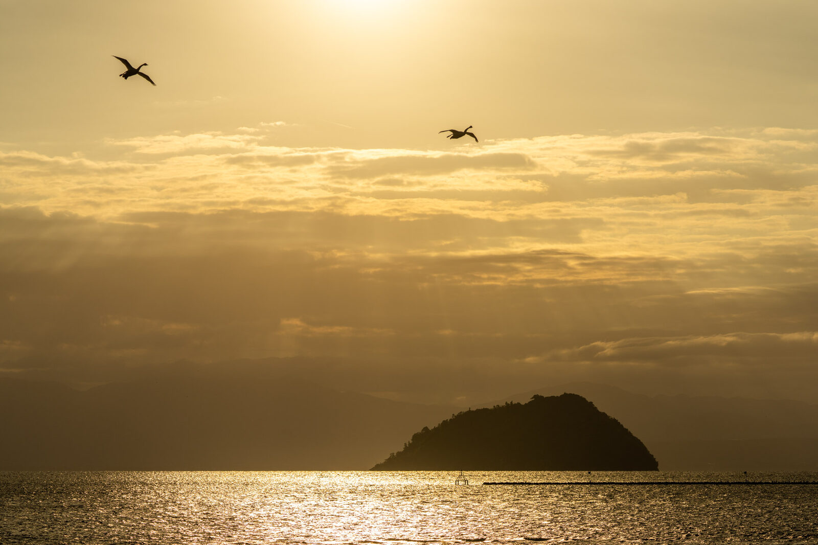 Sunrise over the sea with a small island