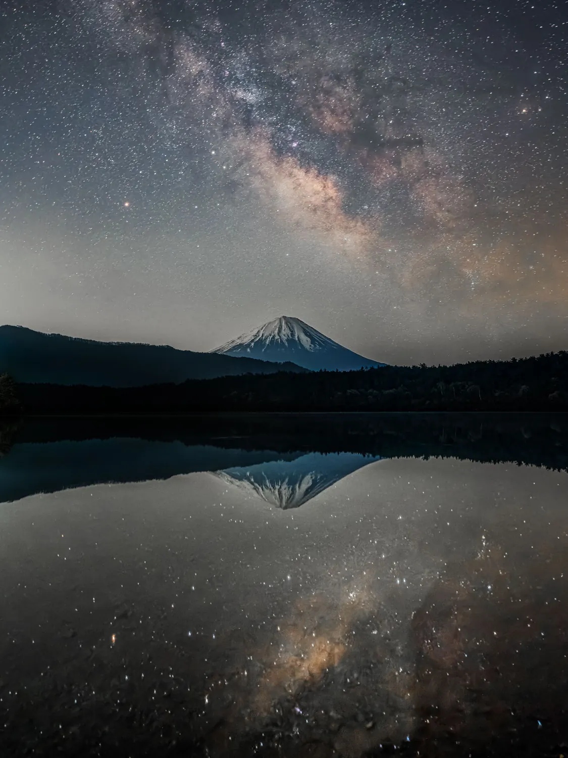 A mountain silhouette over calm water