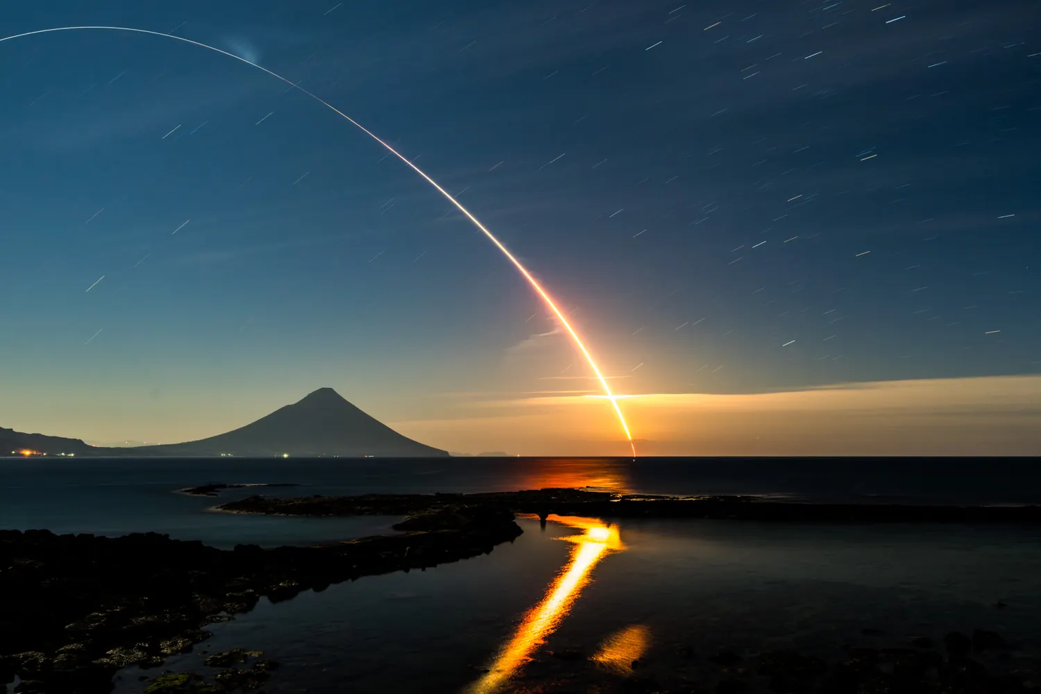 Rocket launch arc over the sea